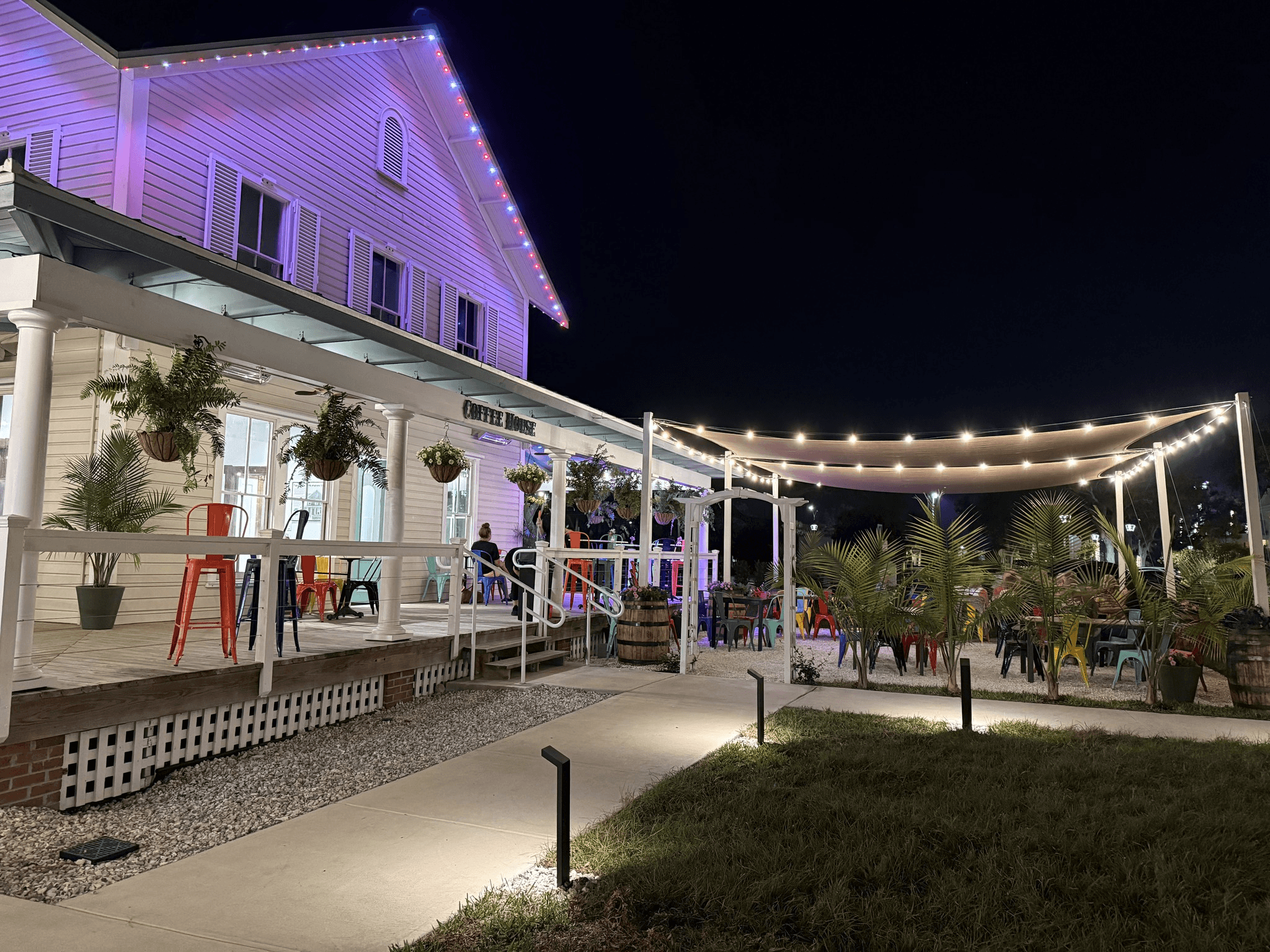 The porch lit with string lights after dark